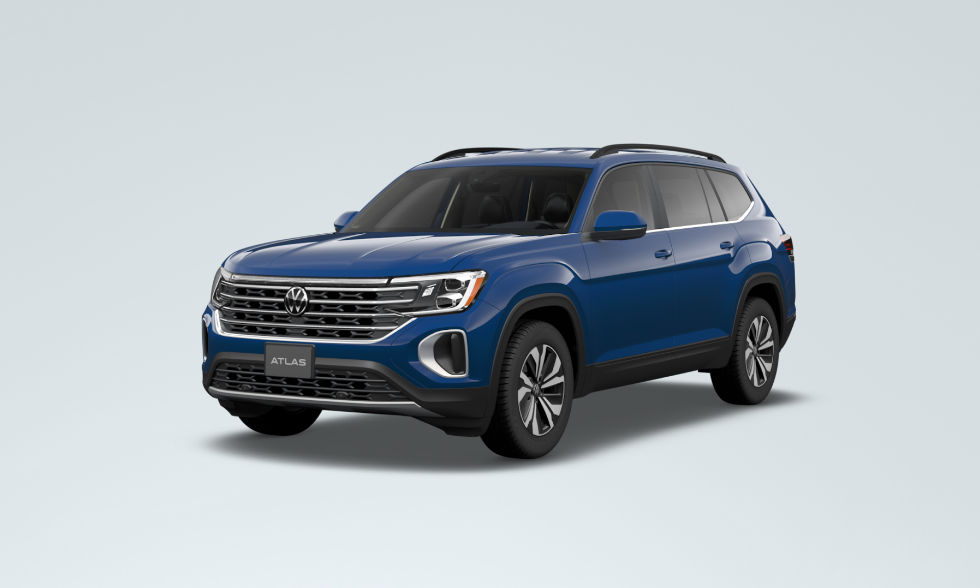 A dark blue SUV facing left, with the Volkswagen logo and a licence plate reading "ATLAS"