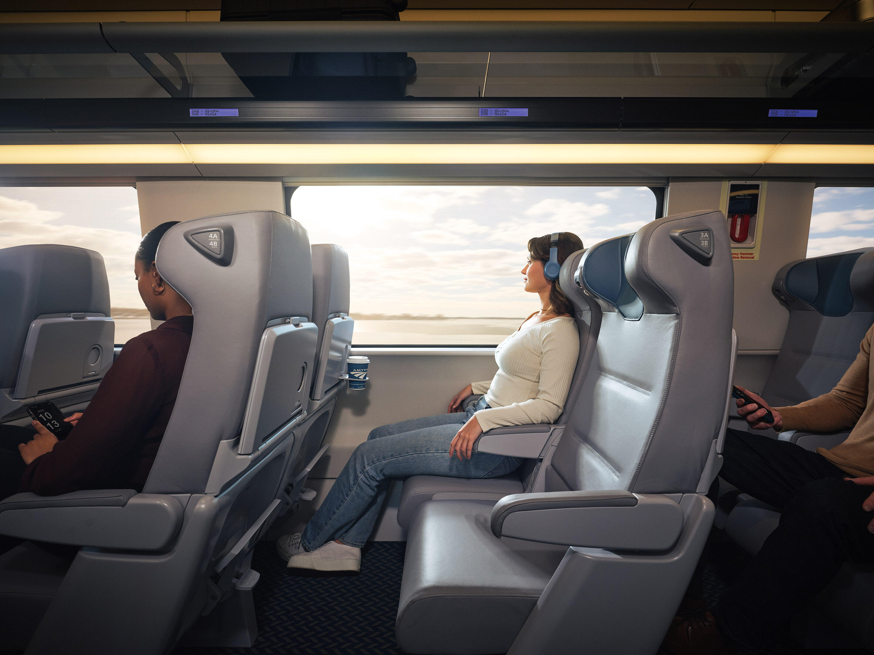 A woman sitting in a train's window seat