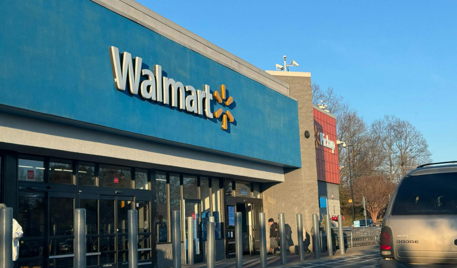 Walmart rings up higher profit, slips on earnings miss
