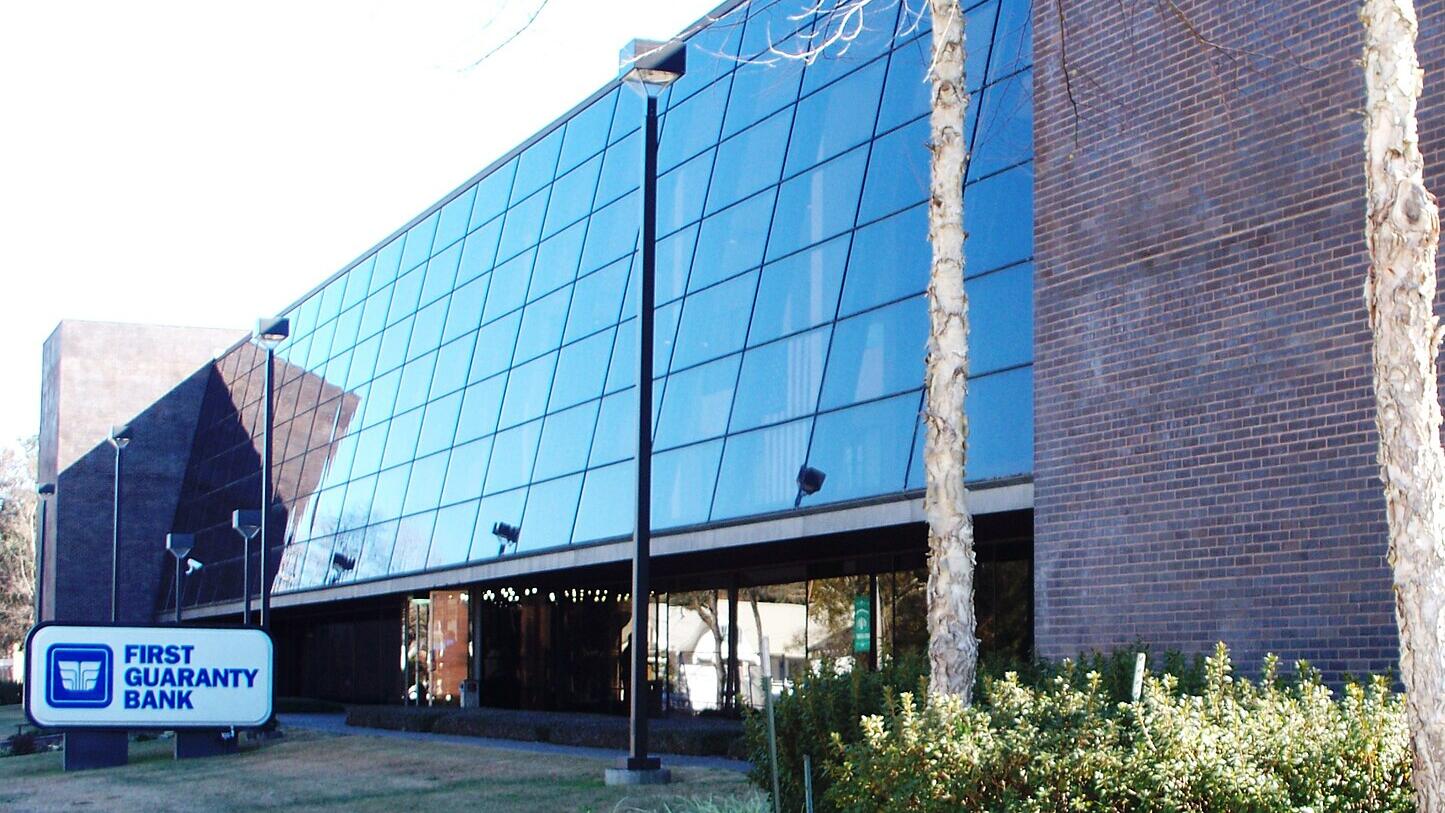 First Guaranty slips to loss on auto parts lease setback