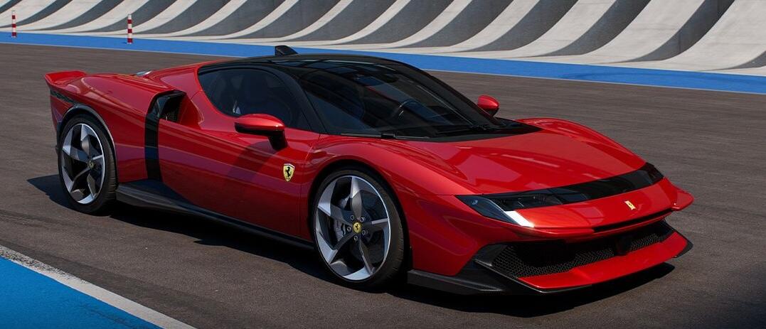 A red sports car on a track with the Ferrari logo below the right mirror