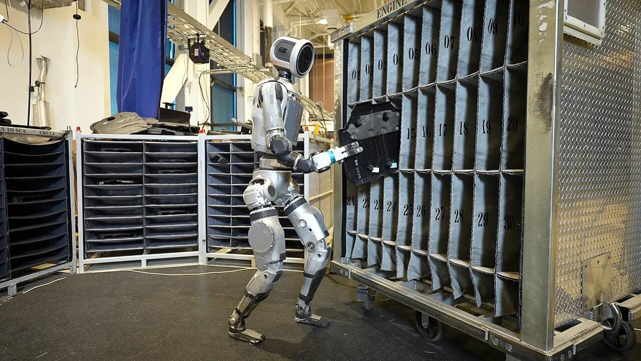 A humanoid robot adding a metal object to a shelf