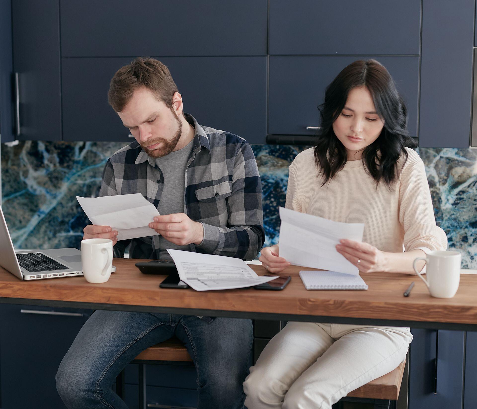 A couple reviewing financial documents at home