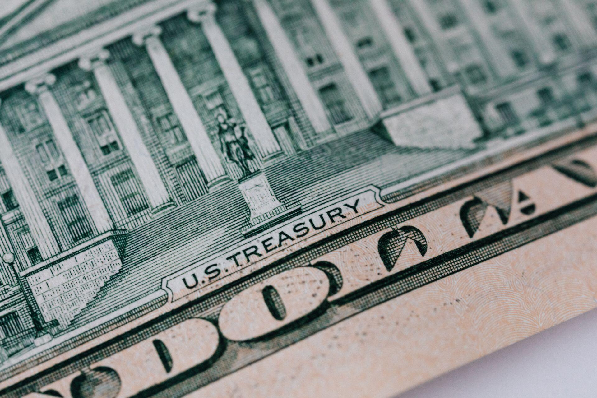 Detailed close-up of the U.S. Treasury text on a dollar bill