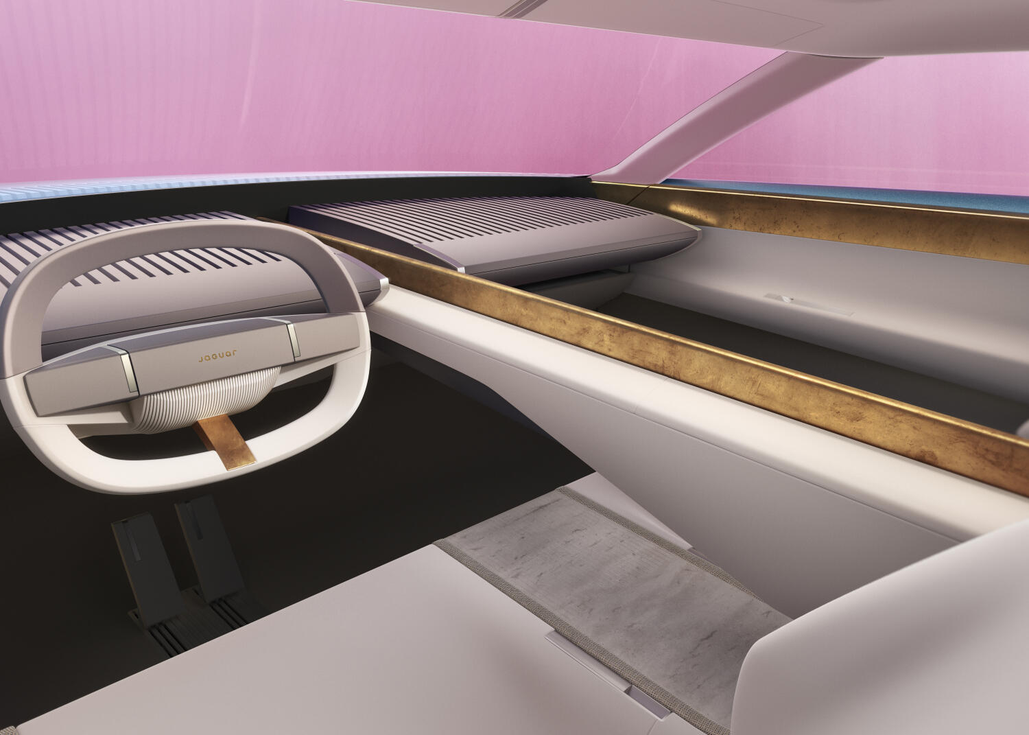 A Jaguar interior with an oval steering wheel and cream upholstery.