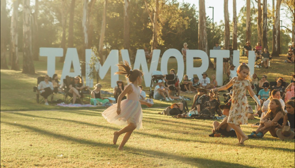 crowd in field in front of Tamworth sign